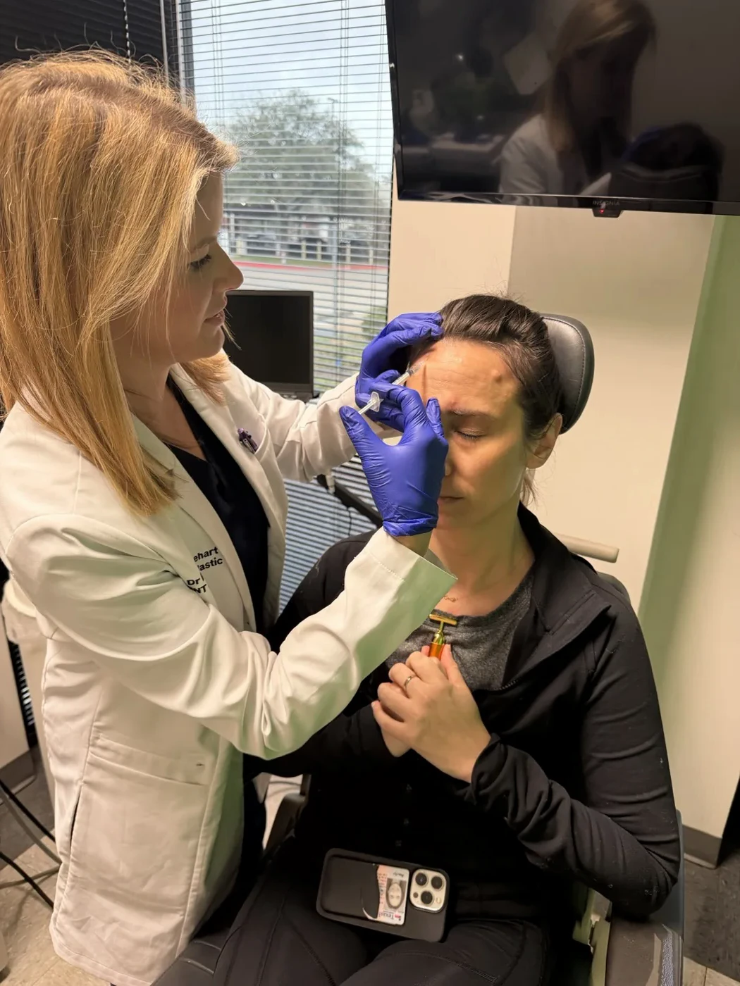 Dr. Bailey Minehart treating a patient at Las Colinas Facial Plastic Surgery